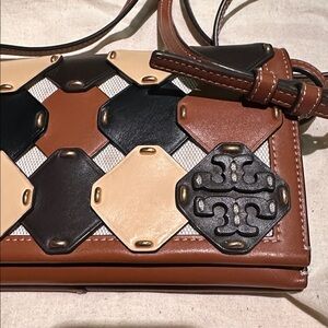 Tori Burch McGraw Wallet Crossbody bag in leather with a die-cut design.